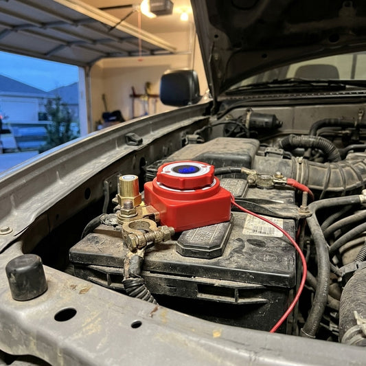 Remote battery disconnect switch installed on a truck battery in a home garage