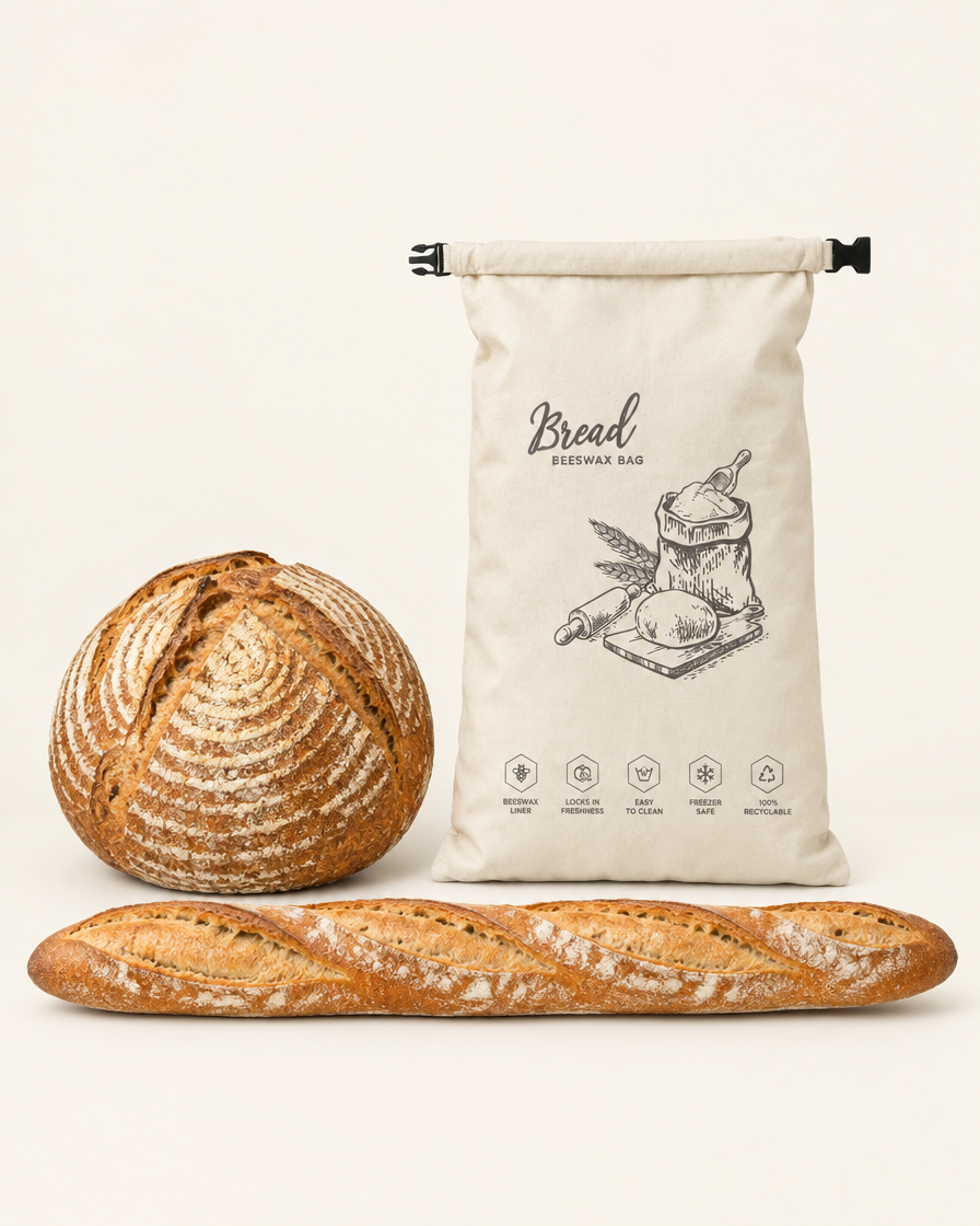 Bread bag beside a sourdough boule and a baguette