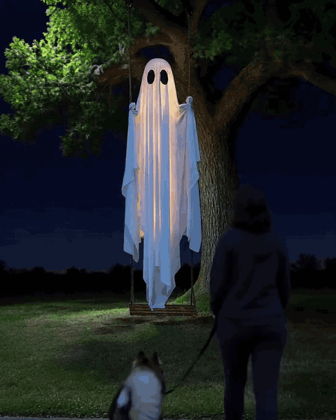 A passer-by stops on the sidewalk to look at the glowing ghost