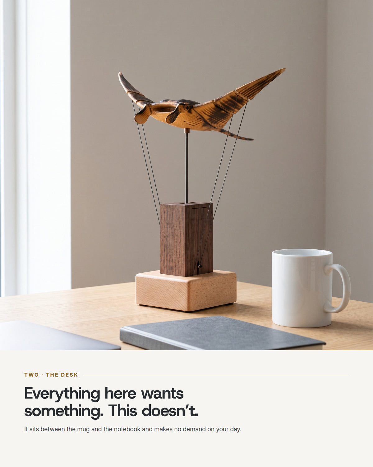 The automaton on a desk between a coffee mug and a notebook