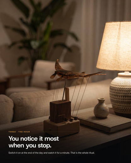 The automaton on a console table under a warm lamp in the evening