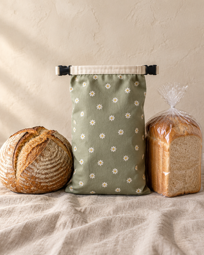 The bread bag beside a sourdough boule and a sliced loaf for scale