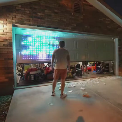 Pixel net lights on a garage door switching from a Christmas tree to Santa