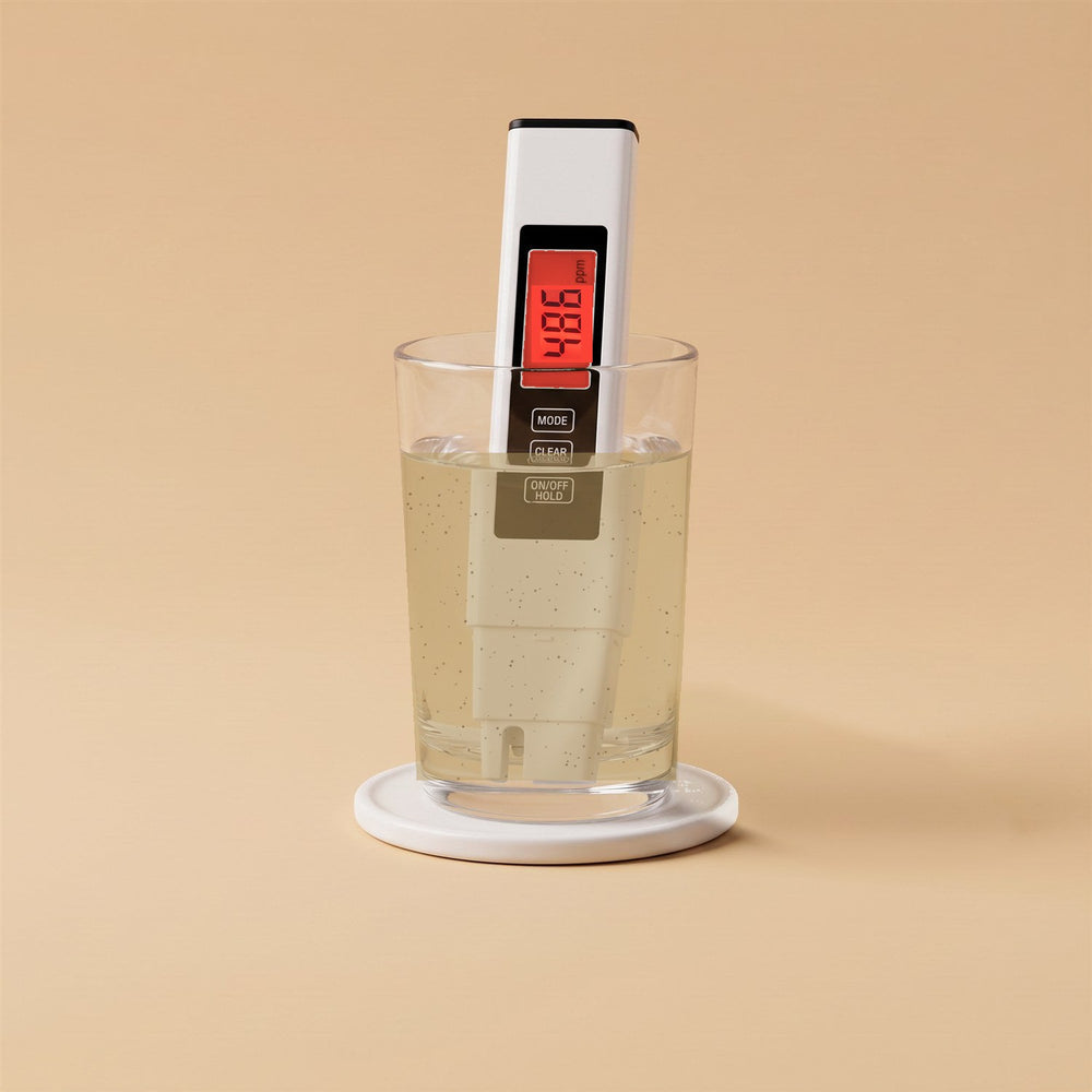 Tester pen showing a red 486 ppm reading in a glass of murky water