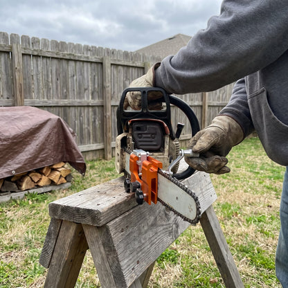 Sharpening a chainsaw chain on a sawhorse in the backyard with TrueTooth