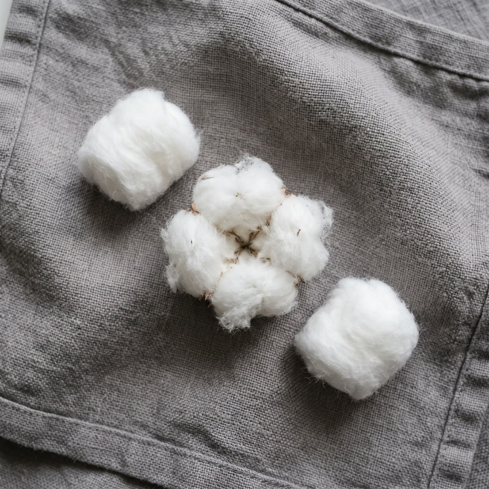 Cotton balls on a grey towel